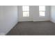 Well-lit bedroom featuring two large windows and carpet at 3912 Highcrest Rd, Indianapolis, IN 46239