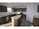 Modern kitchen with dark brown cabinets, stainless steel appliances, and an island at 3912 Highcrest Rd, Indianapolis, IN 46239
