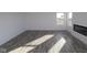 Spacious living room with gray plank flooring and a built-in electric fireplace at 3912 Highcrest Rd, Indianapolis, IN 46239