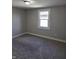 Bedroom with neutral paint and carpet, window, and electrical outlets at 424 N Kealing Ave, Indianapolis, IN 46201