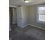 This bedroom features plush carpeting, a window for natural light, and neutral paint at 424 N Kealing Ave, Indianapolis, IN 46201