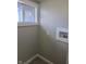 The laundry room is equipped with water hookups and features natural light from a window at 424 N Kealing Ave, Indianapolis, IN 46201