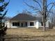 Exterior view of home showcasing the covered back porch and spacious backyard at 5143 Oak Ridge Pl, Columbus, IN 47201