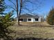 Home exterior featuring a white facade, dark roof and expansive backyard at 5143 Oak Ridge Pl, Columbus, IN 47201
