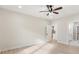 Neutral bedroom with ceiling fan and ensuite bathroom and open doorway to kitchen at 5143 Oak Ridge Pl, Columbus, IN 47201