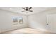 Bright bedroom featuring a ceiling fan and large window overlooking a treed yard at 5143 Oak Ridge Pl, Columbus, IN 47201