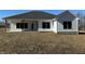 Charming exterior view of a modern farmhouse with vertical siding and a well-manicured lawn on a sunny day at 5143 Oak Ridge Pl, Columbus, IN 47201