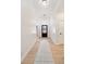 Bright hallway with modern trim, hardwood floors, and a view of the front door and neighborhood at 5143 Oak Ridge Pl, Columbus, IN 47201
