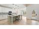 Modern kitchen with stainless steel appliances, a large island, pendant lighting, and an open view to the backyard at 5143 Oak Ridge Pl, Columbus, IN 47201