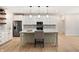 Modern kitchen with stainless steel appliances, a stylish island, and sleek white cabinetry with elegant hardware at 5143 Oak Ridge Pl, Columbus, IN 47201