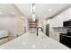 Modern kitchen with stainless steel appliances, a large island, pendant lighting, and a view of the open concept living space at 5143 Oak Ridge Pl, Columbus, IN 47201