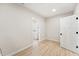 Room with laundry area through doorway; light walls, and light wood look floor at 5143 Oak Ridge Pl, Columbus, IN 47201
