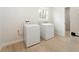 Laundry room with modern appliances, a window for natural light, and wood-look floors at 5143 Oak Ridge Pl, Columbus, IN 47201