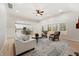 Open-concept living room with neutral decor, a view of the kitchen, and ample seating for entertaining guests at 5143 Oak Ridge Pl, Columbus, IN 47201