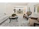 Elegant living area showcasing stylish seating, a chic coffee table, and a seamless transition to the modern kitchen at 5143 Oak Ridge Pl, Columbus, IN 47201