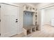 Mudroom area featuring a built-in bench, storage cubbies, coat hooks, and a white door at 5143 Oak Ridge Pl, Columbus, IN 47201