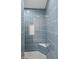 Walk in shower with blue tile surround, mosaic tile floor, and recessed niche at 5143 Oak Ridge Pl, Columbus, IN 47201