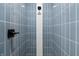 Enclosed shower with bright blue tile, recessed niche, and mosaic accent at 5143 Oak Ridge Pl, Columbus, IN 47201
