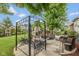 A relaxing outdoor patio featuring a swing and an outdoor fireplace with ample seating at 10346 Strongbow Rd, Fishers, IN 46040