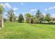 Spacious backyard with mature trees and a swing set; perfect for families to enjoy outdoor activities at 10346 Strongbow Rd, Fishers, IN 46040