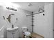 Clean bathroom featuring white tiling, updated fixtures and hardware and a shower with a rainfall showerhead at 10346 Strongbow Rd, Fishers, IN 46040
