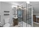 Modern bathroom with walk-in shower, black fixtures, and neutral tiling at 10346 Strongbow Rd, Fishers, IN 46040