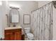 Traditional bathroom with a wood vanity, framed mirror, and patterned shower curtain at 10346 Strongbow Rd, Fishers, IN 46040
