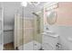Bright bathroom featuring white wainscoting, a glass shower, and ornate light fixtures at 10346 Strongbow Rd, Fishers, IN 46040