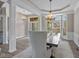 Inviting dining area with hardwood floors, large windows, and stylish chandelier at 10346 Strongbow Rd, Fishers, IN 46040