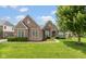 Charming brick home featuring a well-manicured lawn and professionally landscaped flowerbeds at 10346 Strongbow Rd, Fishers, IN 46040