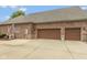 Three-car garage showcasing ample parking space, brick siding and a spacious driveway at 10346 Strongbow Rd, Fishers, IN 46040
