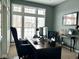 Modern home office with a large window providing natural light and comfortable seating at 10346 Strongbow Rd, Fishers, IN 46040