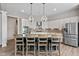 Elegant kitchen island with seating, stainless appliances, pendant lights, and mosaic tile backsplash at 10346 Strongbow Rd, Fishers, IN 46040