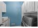 Modern laundry room featuring washer, dryer, and cabinet at 10346 Strongbow Rd, Fishers, IN 46040