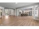 Spacious living area with kitchen, hardwood floors, columns, and view into formal dining area at 10346 Strongbow Rd, Fishers, IN 46040
