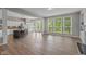 Open concept living room with hardwood floors, bright windows, and seamless flow into kitchen at 10346 Strongbow Rd, Fishers, IN 46040