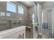 Walk-in shower with gray tile and built-in seat at 16341 Drayton Way, Fortville, IN 46040