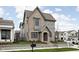 Charming two-story home with gray brick and siding, a covered entryway, and manicured landscaping at 1667 Midland Main St, Westfield, IN 46074
