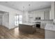 Modern kitchen with white cabinets, quartz countertops and island at 1667 Midland Main St, Westfield, IN 46074