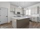 Modern kitchen with white cabinets, quartz countertops, and an island at 1667 Midland Main St, Westfield, IN 46074