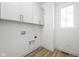 Laundry room with upper cabinets and vinyl flooring at 1667 Midland Main St, Westfield, IN 46074