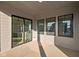Covered porch with concrete flooring and multiple windows at 1667 Midland Main St, Westfield, IN 46074