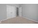 Bedroom with neutral carpet and grey walls, features a double door closet at 16946 Cattle Hollow Ln, Noblesville, IN 46060