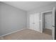 Bedroom with neutral carpet and grey walls, features a double door closet and two doors at 16946 Cattle Hollow Ln, Noblesville, IN 46060