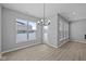 Bright dining area features wood floors, modern light fixture and a large window with backyard view at 16946 Cattle Hollow Ln, Noblesville, IN 46060