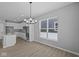 Light-filled dining area and kitchen featuring modern appliances and a kitchen island at 16946 Cattle Hollow Ln, Noblesville, IN 46060