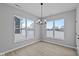 Bright dining room features modern chandelier, wood floors, and large windows at 16946 Cattle Hollow Ln, Noblesville, IN 46060