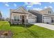 Inviting home boasts a two-car garage, well-kept lawn, and appealing architectural details at 16946 Cattle Hollow Ln, Noblesville, IN 46060