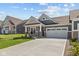 Attractive home features a well-maintained lawn, concrete driveway, and a welcoming exterior design at 16946 Cattle Hollow Ln, Noblesville, IN 46060