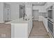 Modern kitchen features white cabinets, quartz countertops, stainless steel appliances, and large center island at 16946 Cattle Hollow Ln, Noblesville, IN 46060